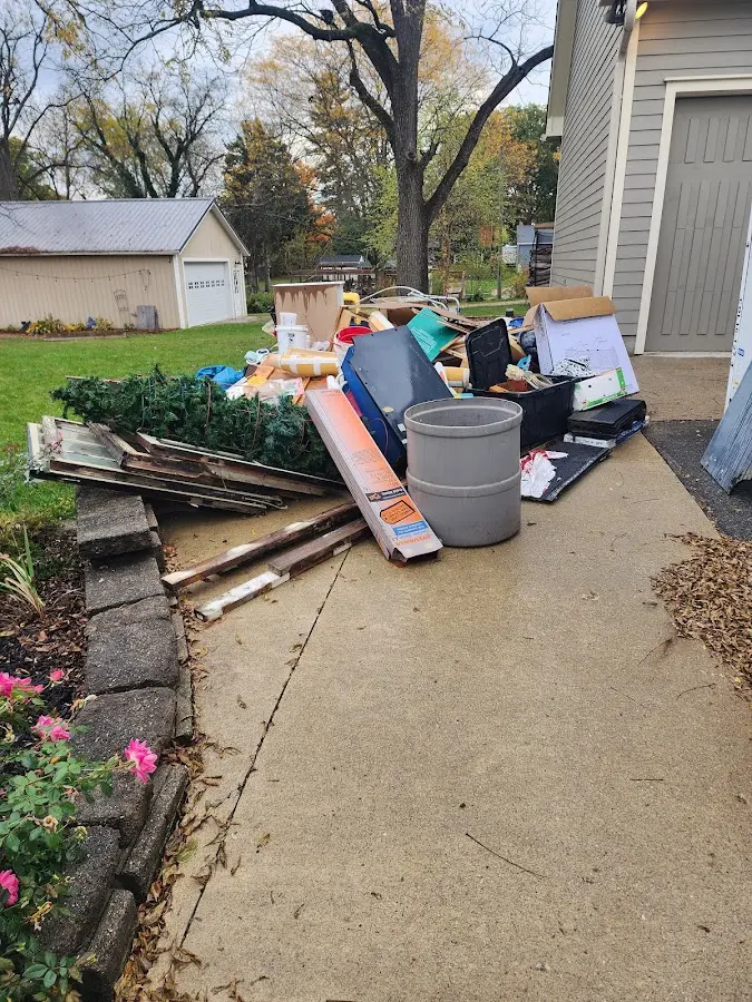 Dumpster being loaded with debris for Roofing Dumpster Rental in O'Hara